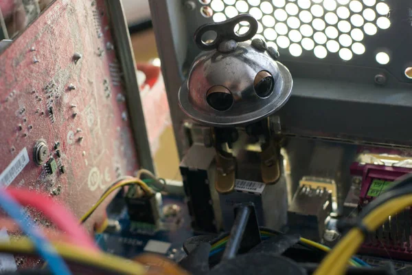 Beautiful photo of little robot repairing computer