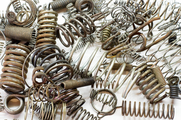 Close up of metal springs and coils on white background