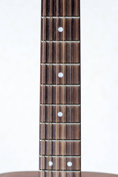Close-up neck of guitar on a white background