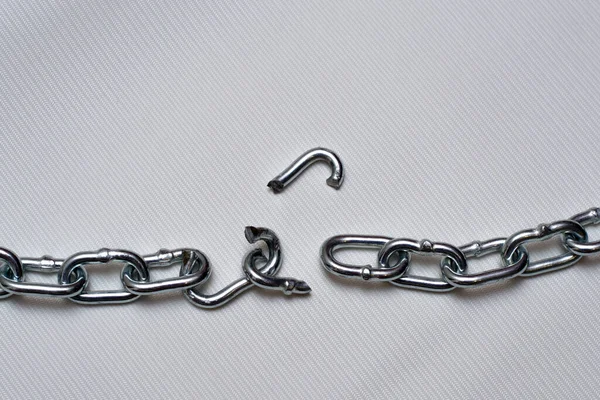 Photo of broken metallic chain on white background