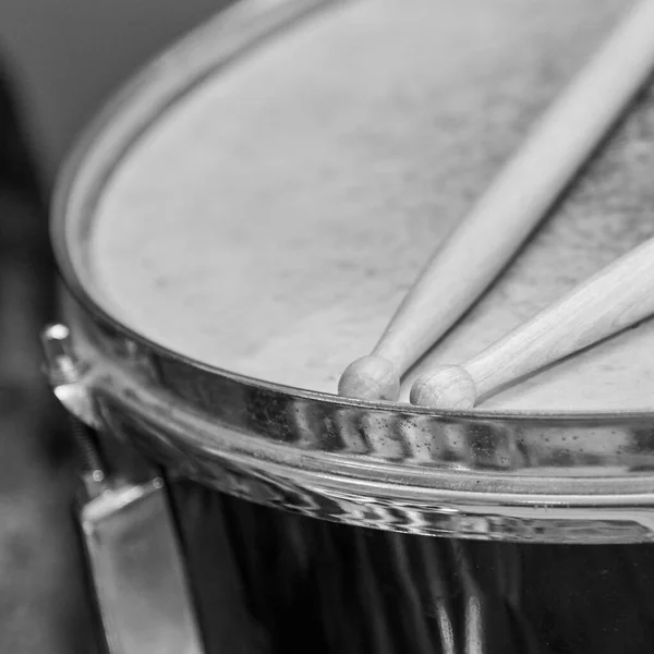 stock image Two wooden drumsticks lie on the drum, black and white photo