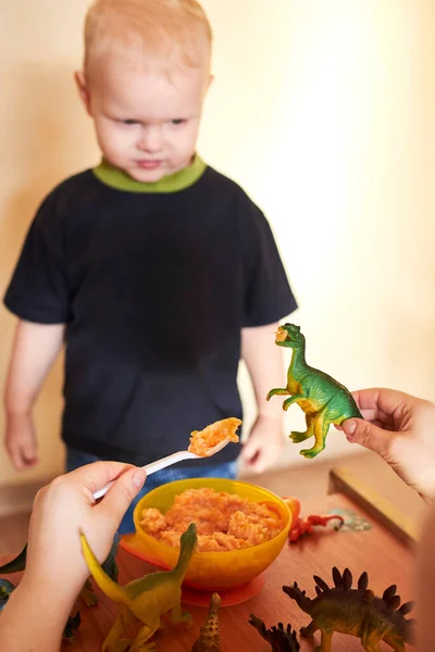 Mom Feeds Toy Dinosaurs Spoon Mom Plays Her Son — Stock Photo, Image