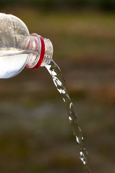 Pure fresh clear water is poured from a plastic bottle.