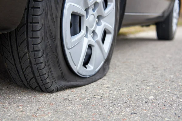 Flat tire of a passenger car, trouble on the road.