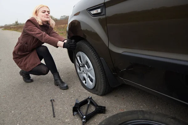 Genç Sarışın Bir Kadın Arabasının Yanında Patlak Lastikli Bir Anahtarla — Stok fotoğraf