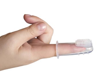 Silicone brush for cleaning the teeth of babies, put on mother's finger, isolated on white.