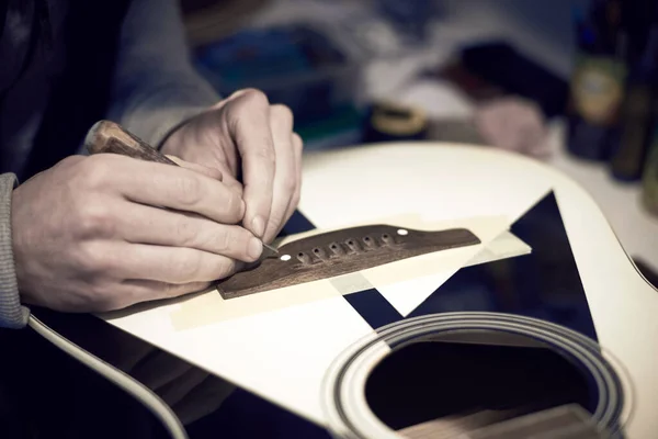 Trabajador Servicios Repara Una Guitarra Con Una Herramienta Foto Tonificada — Foto de Stock