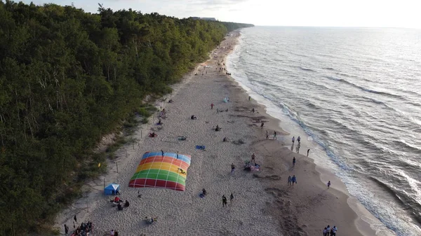 View of the sandy beach. Summer landscape, beach. Aerial view of people on the beach. Relax on the beach in Poland. Top view from the drone
