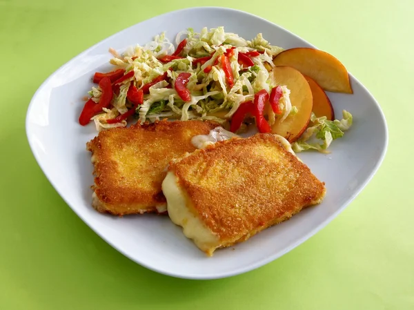 Queijo amarelo, duro revestido de migalhas de pão e ovos com salada de legumes — Fotografia de Stock