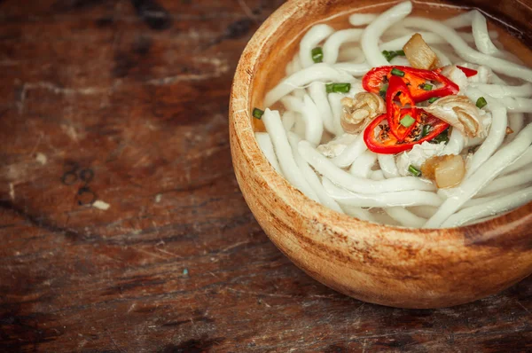 Penutupan udon mie dalam mangkuk kayu di lantai kayu latar belakang — Stok Foto