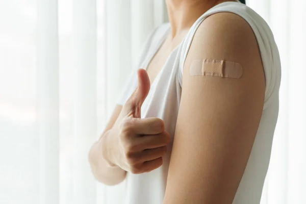 Healthy woman thumb up after getting vaccinated immunity, vaccination, vaccinated patient, vaccine roll-out program