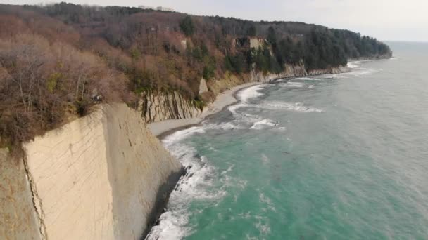 Aerial view of Kiseleva rock, Krasnodar Territory. People are standing on top of cliff. Rock consists of white slabs and layers. Storm excites azure sea. Unique landscape. Spring — Stock Video