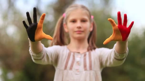 Kid hands painted in Belgium flag color show symbol of heart and love gesture — Stock Video