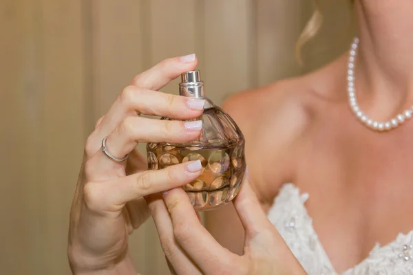 bride hands with perfume