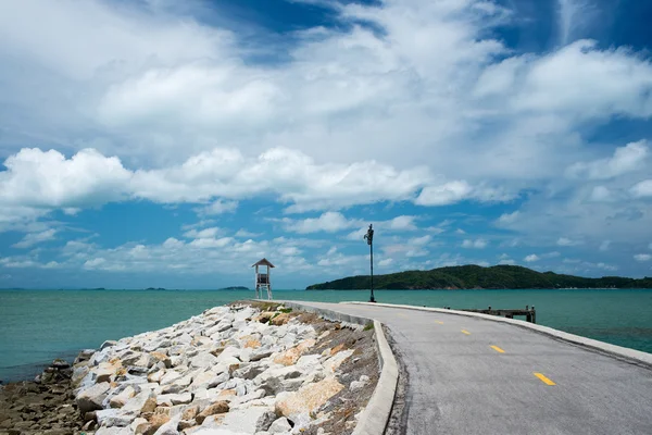 Pier of rock foundation and lighthouse — Stock Photo, Image