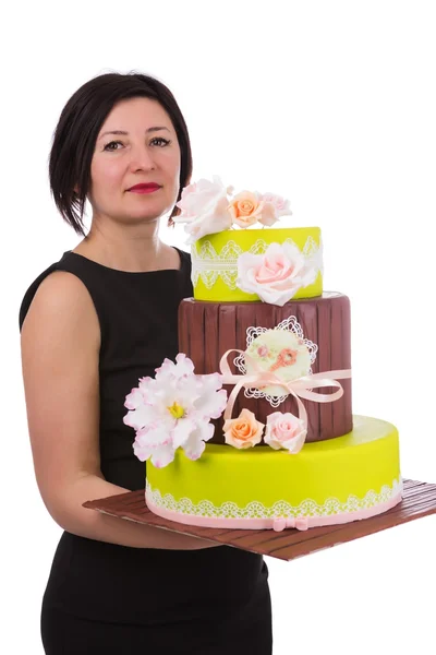 Aged woman holding a wedding cake. — Stock Photo, Image
