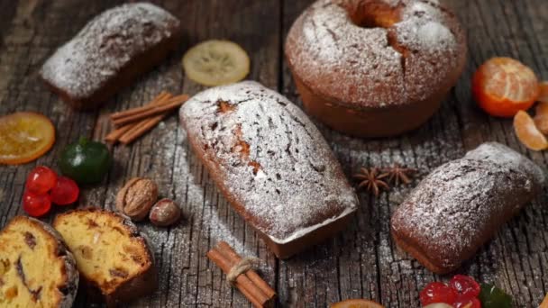 Christmas composition of dried fruits and stollen, with tangerine, on a wooden textured table, with spices. At Christmas. — Stock Video