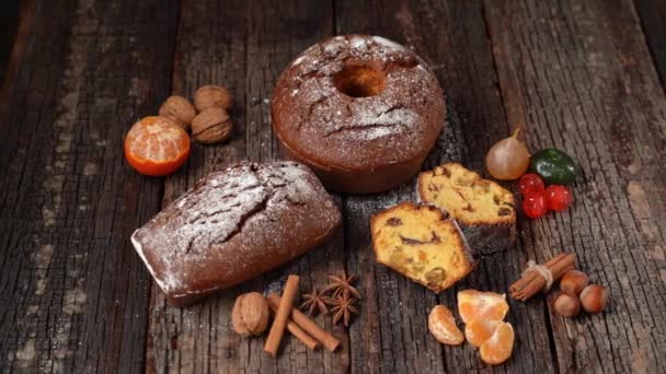 Christmas composition of dried fruits and stollen, with tangerine, on a wooden textured table, with spices. At Christmas. — Stock Video