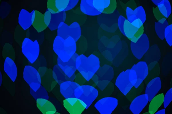 Corazones borrosos multicolores, bokeh, luces sobre un fondo negro, un símbolo de amor por el Día de San Valentín. —  Fotos de Stock