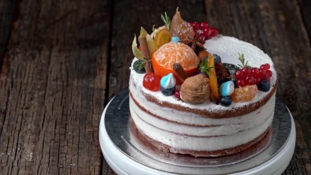 Festlicher Neujahrskuchen dekoriert mit allerlei Obst, das sich auf einem rotierenden Ständer dreht. — Stockvideo