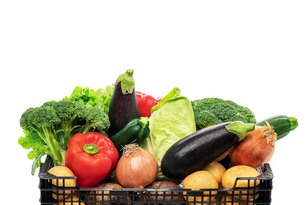 Colorful vegetable basket isolated and filled with broccoli, lettuce, aubergines, onions, zucchini, peppers and potatoes. — Stock Photo, Image