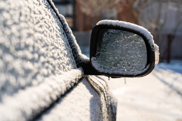 Car covered with ice and icicles after freezing rain. Ice covered car window close up. Bad winter weather, ice stormWinter frosty scenes.