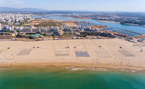 Aerial view, birds eye view of the Portuguese city of Portimao beaches and the tourist area of the Algarve. Summer is the tourism season.