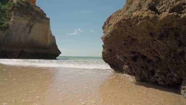Moving forward, stabilized, at sea with waves, beach Prainha, for European tourists, in summer. Portugal Portimao — Stock Video