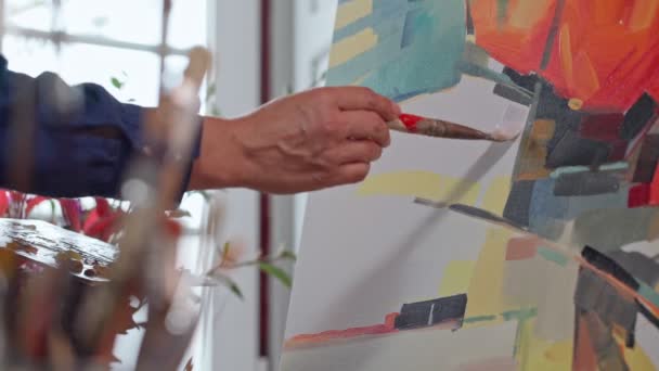 Woman artist applying paint with brush strokes on canvas, brush close-up. Abstract painting. — Stock Video