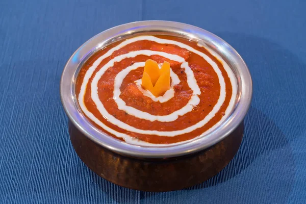 Sopa indiana de chiken tikka masala. Tomate creme aromático em uma placa de metal em um fundo azul. — Fotografia de Stock