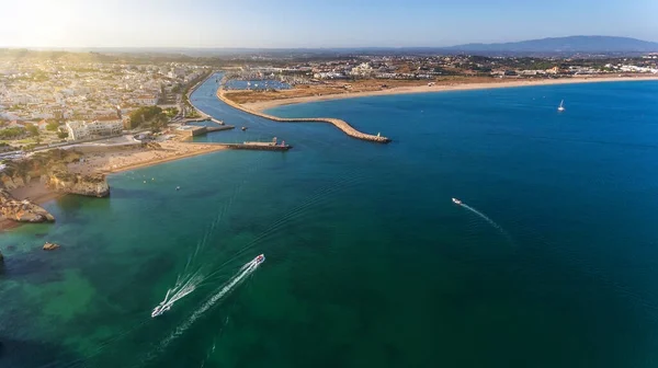 Aerial view from the sky of the Portuguese coastline of the Algarve zone of Lagos city. Boats and ships are moving, Sunny day. — Stock Photo, Image