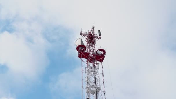 Mavi gökyüzü ve hareket eden bulutların arka planına karşı televizyon ve radyo yayın anteninin alt görüntüsü. Akıllı telefonlar için 5G frekansının geliştirilmesi tartışması. — Stok video