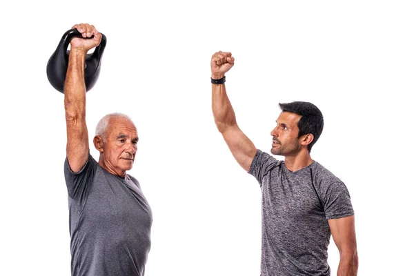 Old man with a middle-aged personal trainer is conducting a fitness workout. On an isolated white background. White background. — Stock Photo, Image