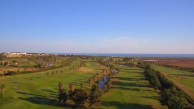 Deniz kenarındaki yeşil golf sahaları. Salgados plajı. Portekiz, Albufeira. Hava görünümü.