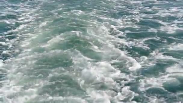 Close-up of the surface of a wave in slow motion, from a boat to a yacht while sailing. — Stock Video