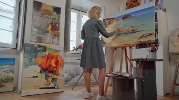 Kvinna konstnär teckningar, förbereder sig för att skapa en abstrakt målning bild. I galleriets egen ateljé, studio. — Stockvideo