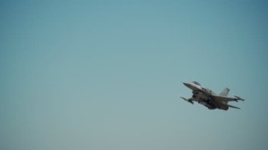 F-16 askeri Amerikan jet uçağı taktik eğitim uçuşu için kalkıyor. Süper sonik motorlardan yangın çıkışları.