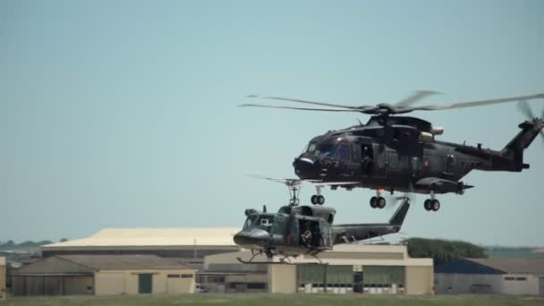 An American military helicopter flies in slow motion, near, on military exercises, over the base of the armed forces. — Stock Video