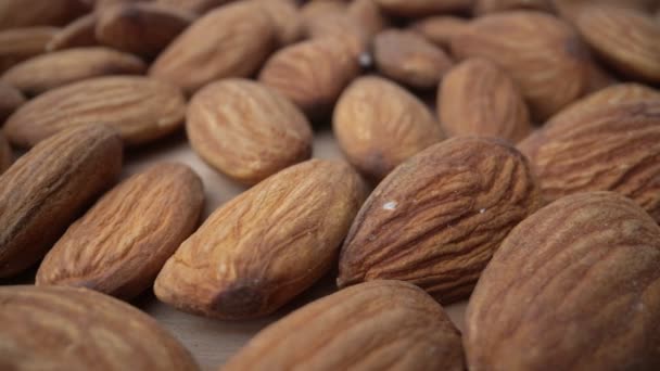 Extreme macro, bottom movement of almond kernels, for vegetarians and nutritious food. Biologically pure. — Stock Video