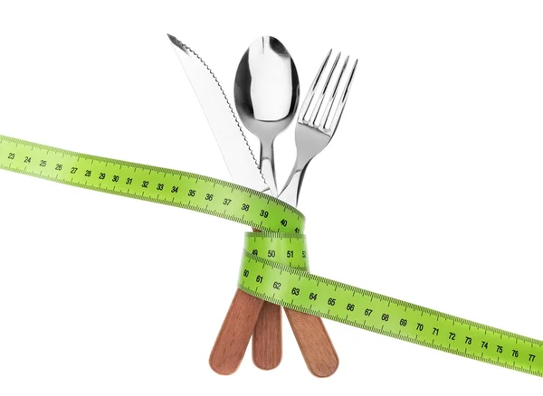 Fork knife and spoon in a tape meter. To measure the diet. — Stock Photo, Image