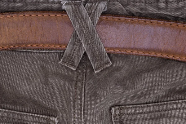 Brown jeans with a belt and binding. Close-up of men's clothing. — Stock Photo, Image