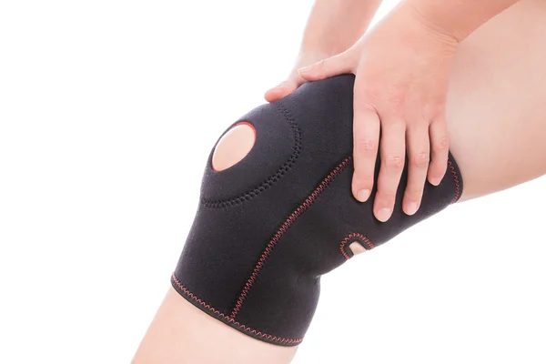 Knee injury. Girl holds hands bandage on his leg. — Stock Photo, Image
