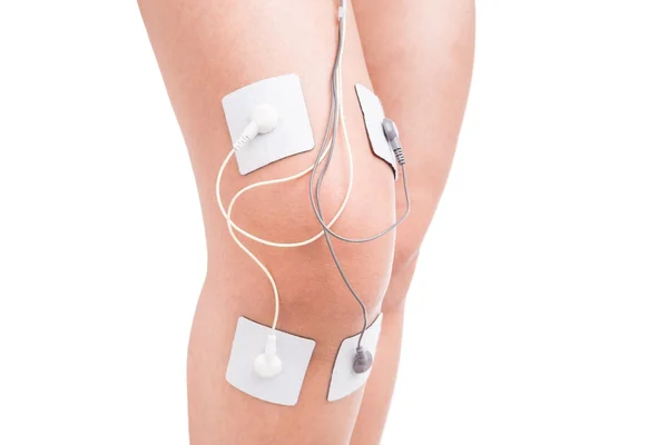 Electrostimulator massager on her knee. Injury athlete. — Stock Photo, Image