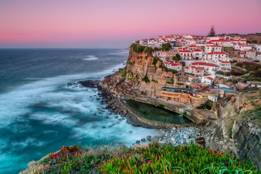 Sunset in the town Azenhas do Mar. With natural pool. clipart