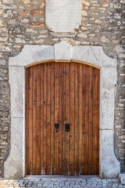 Old decorative door in a stone wall. Traditionally Portuguese. — Stock Photo, Image