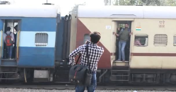 Man checking time while waiting at railway station — Stock Video