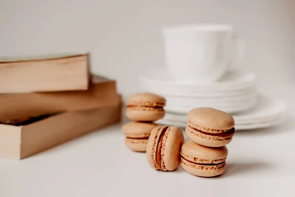 pasta in a coffee cup. caramelized macaroons. Light tortillas with dessert. Pasta on a white plate with books. Cozy winter photography