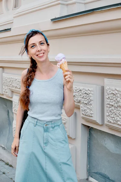 Tatilde dondurma yiyen bir kadın. Gülümseyen kız Avrupa 'da tatillerde dışarıda dondurma yerken eğleniyor..