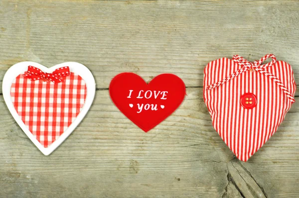 Three different hearts on wood — Stock Photo, Image