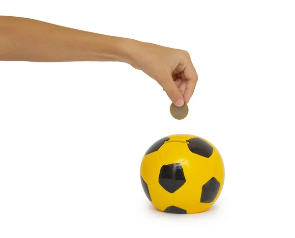 Hand putting coin into a moneybox — Stock Photo, Image